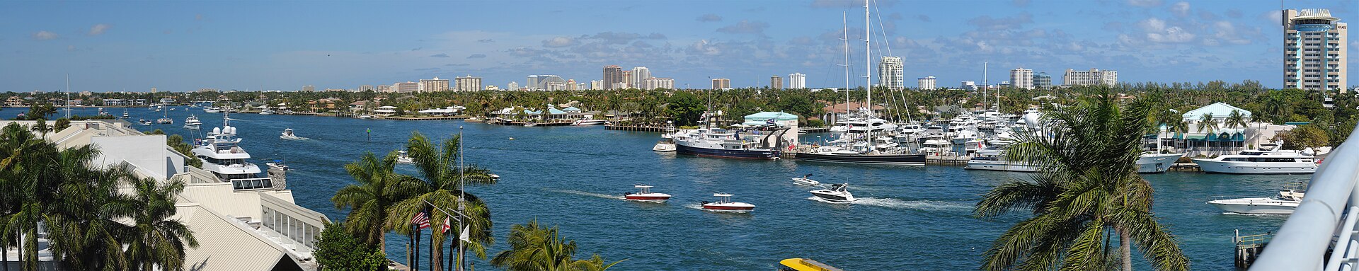 Panorama of the Fort Lauderdale Intracoastal Waterway lined with boats and palm trees